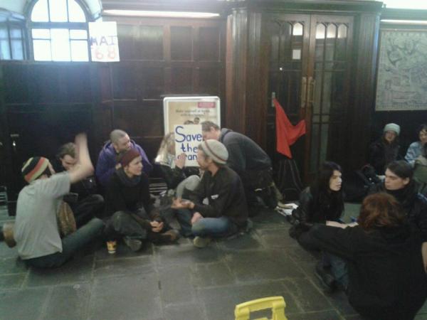 Students sit on the floor of the occupied AIB branch in Shop Street, Galway.